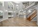 Spacious living area with wood floors, high ceilings, and abundant natural light, with staircase and backyard access at 1628 Se 29Th Ter, Ocala, FL 34471