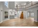 Spacious open-concept living area with a second-floor balcony and hardwood staircase at 1628 Se 29Th Ter, Ocala, FL 34471