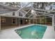 Screened-in pool with attached wooden deck surrounded by home's exterior at 1628 Se 29Th Ter, Ocala, FL 34471