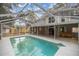 Screened-in pool with attached wooden deck surrounded by home's exterior at 1628 Se 29Th Ter, Ocala, FL 34471