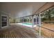 Covered deck overlooking a screened-in pool and landscaped backyard at 1628 Se 29Th Ter, Ocala, FL 34471