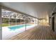 Screened-in pool with a covered patio and wooden deck at 1628 Se 29Th Ter, Ocala, FL 34471