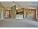 Bright living room featuring neutral walls, vaulted ceiling, carpet flooring, and pendant lighting over the kitchen bar at 1847 Sw Breezy Point Dr, Dunnellon, FL 34431