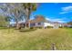 Beautiful backyard featuring lush green lawn, mature landscaping, and serene views of the surrounding neighborhood at 1956 Nw 50Th Cir, Ocala, FL 34482
