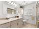 Bright bathroom featuring a single sink vanity, framed mirror, and a tiled walk-in shower with glass door at 1956 Nw 50Th Cir, Ocala, FL 34482