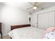 Bright bedroom featuring a plush bed, ceiling fan, and a spacious closet for ample storage at 1956 Nw 50Th Cir, Ocala, FL 34482