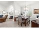 Bright dining room featuring a modern chandelier, elegant furnishings, and an arched doorway at 1956 Nw 50Th Cir, Ocala, FL 34482