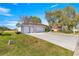 Charming home with a spacious three car garage and long driveway, enhanced by the well-maintained front lawn at 1956 Nw 50Th Cir, Ocala, FL 34482