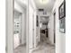 Inviting hallway with neutral carpet, fresh white paint, and doorways leading to various rooms in the home at 1956 Nw 50Th Cir, Ocala, FL 34482