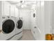 Bright laundry room with white washer and dryer and closet space for storage at 1956 Nw 50Th Cir, Ocala, FL 34482