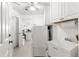 Bright laundry room with white washer and dryer, sink and tile floor at 1956 Nw 50Th Cir, Ocala, FL 34482