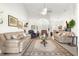Open-concept living room featuring vaulted ceilings, tile floors, and comfortable furnishings at 1956 Nw 50Th Cir, Ocala, FL 34482