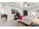 Spacious carpeted main bedroom featuring tray ceilings, a ceiling fan, and sliding glass doors at 1956 Nw 50Th Cir, Ocala, FL 34482