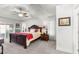 Main bedroom suite featuring a ceiling fan, plush bedding, and serene ambiance at 1956 Nw 50Th Cir, Ocala, FL 34482