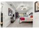 Spacious carpeted main bedroom featuring tray ceilings, a ceiling fan, sliding glass doors, and furnishings at 1956 Nw 50Th Cir, Ocala, FL 34482