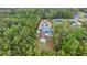 Aerial view of house with screened pool, long circular drive, and mature landscaping at 20280 Sw 69Th Pl, Dunnellon, FL 34431
