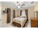 Cozy bedroom featuring neutral walls, tiled flooring, ceiling fan, and a window with blinds at 20280 Sw 69Th Pl, Dunnellon, FL 34431