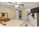 Bedroom includes ceiling fan, tiled flooring, door to closet with TV, and furnishings at 20280 Sw 69Th Pl, Dunnellon, FL 34431
