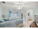 A peaceful bedroom featuring a queen bed, soft blue walls, and an ensuite bathroom with dual sinks at 20280 Sw 69Th Pl, Dunnellon, FL 34431