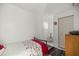 An uncluttered bedroom featuring a cozy single bed, a patterned rug, and a functional closet for storage at 20280 Sw 69Th Pl, Dunnellon, FL 34431