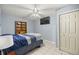 A serene bedroom with a ceiling fan, a TV, and a built-in bookshelf creates a comfortable living space at 20280 Sw 69Th Pl, Dunnellon, FL 34431