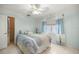Serene bedroom featuring a queen bed, soft blue walls, ample natural light, and neutral tile flooring at 20280 Sw 69Th Pl, Dunnellon, FL 34431