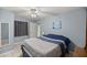 A tranquil bedroom with a ceiling fan, a mirror, and a tasteful seascape wall print offers a peaceful retreat at 20280 Sw 69Th Pl, Dunnellon, FL 34431