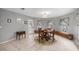 Bright dining area featuring a round table with chairs and an outdoor view through multiple windows at 20280 Sw 69Th Pl, Dunnellon, FL 34431
