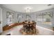 Light filled dining area with a round table, chairs, and built in benches next to the large windows at 20280 Sw 69Th Pl, Dunnellon, FL 34431