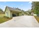 Exterior view of home featuring an attached garage, long driveway and well maintained lawn at 20280 Sw 69Th Pl, Dunnellon, FL 34431