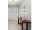 Bright foyer featuring beautiful tile flooring, a wooden console table, and decorative lighting at 20280 Sw 69Th Pl, Dunnellon, FL 34431