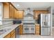 Spacious kitchen featuring stainless steel appliances, a large island, and custom cabinetry at 20280 Sw 69Th Pl, Dunnellon, FL 34431