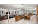A light-filled kitchen with a central island featuring a sink that connects to the dining and living area at 20280 Sw 69Th Pl, Dunnellon, FL 34431