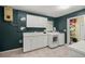 Laundry room includes tiled floor, washer, dryer, and storage cabinets at 20280 Sw 69Th Pl, Dunnellon, FL 34431