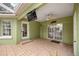 A covered patio featuring tile flooring, a ceiling fan, and a wall-mounted television for outdoor entertainment at 20280 Sw 69Th Pl, Dunnellon, FL 34431
