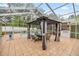 Spacious screened-in patio features a gazebo, an outdoor kitchen, and a view of the inviting swimming pool at 20280 Sw 69Th Pl, Dunnellon, FL 34431