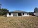 The backyard features a covered patio and ample space for outdoor activities at 2602 Sw 154Th Ln, Ocala, FL 34473