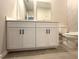 Bathroom featuring a double sink vanity with white cabinets and light-grey tile floors at 2602 Sw 154Th Ln, Ocala, FL 34473