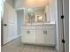 A bathroom features a double sink vanity with a mirror and modern fixtures, plus tiled floors at 2602 Sw 154Th Ln, Ocala, FL 34473