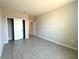 Bright bedroom with light-grey wood-look tile flooring, closet, and neutral walls at 2602 Sw 154Th Ln, Ocala, FL 34473