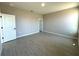 A bedroom with wood-look tile flooring and light gray walls offers natural light and an open floor plan at 2602 Sw 154Th Ln, Ocala, FL 34473