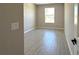 Bedroom featuring a window, light-grey walls, and light-grey wood-look tile floors at 2602 Sw 154Th Ln, Ocala, FL 34473