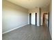 Bright bedroom with light-grey wood-look tile flooring, closet, and neutral walls at 2602 Sw 154Th Ln, Ocala, FL 34473