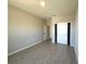 Bright bedroom with light-grey wood-look tile flooring, closet, and neutral walls at 2602 Sw 154Th Ln, Ocala, FL 34473