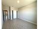 Bright bedroom with light-grey wood-look tile flooring, closet, and neutral walls at 2602 Sw 154Th Ln, Ocala, FL 34473