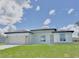 New construction, single-story home featuring a two-car garage door, stone accents, and a freshly cut lawn at 2602 Sw 154Th Ln, Ocala, FL 34473
