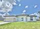 New construction, single-story home featuring a two-car garage door, stone accents, and a freshly cut lawn at 2602 Sw 154Th Ln, Ocala, FL 34473