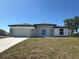 Modern home with white facade, stone accents, and a two-car garage on a sunny day at 2602 Sw 154Th Ln, Ocala, FL 34473