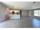 Open floor plan features a kitchen with a kitchen island and stainless steel appliances at 2602 Sw 154Th Ln, Ocala, FL 34473