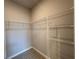 A walk-in closet offers ample shelving for clothes and accessories, and gray floors at 2602 Sw 154Th Ln, Ocala, FL 34473